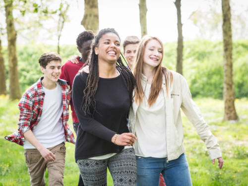 Group of teenagers walking and smiling