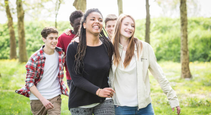 Group of teenagers walking and smiling