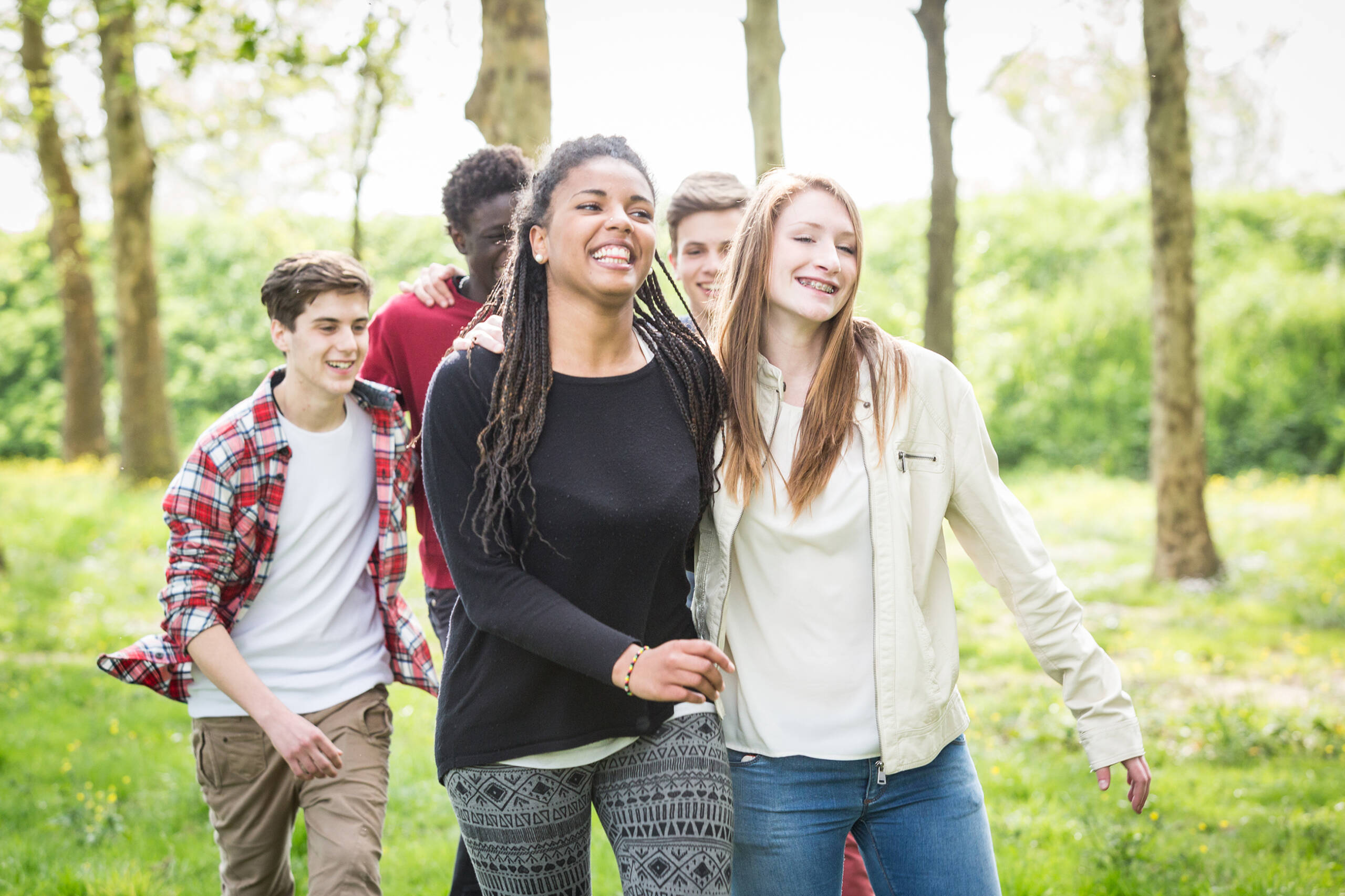 Group of teenagers walking and smiling