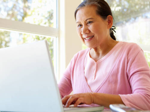 Lady working on laptop smiling