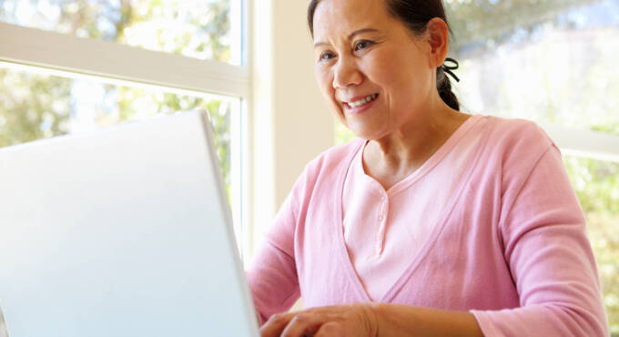Lady working on laptop smiling