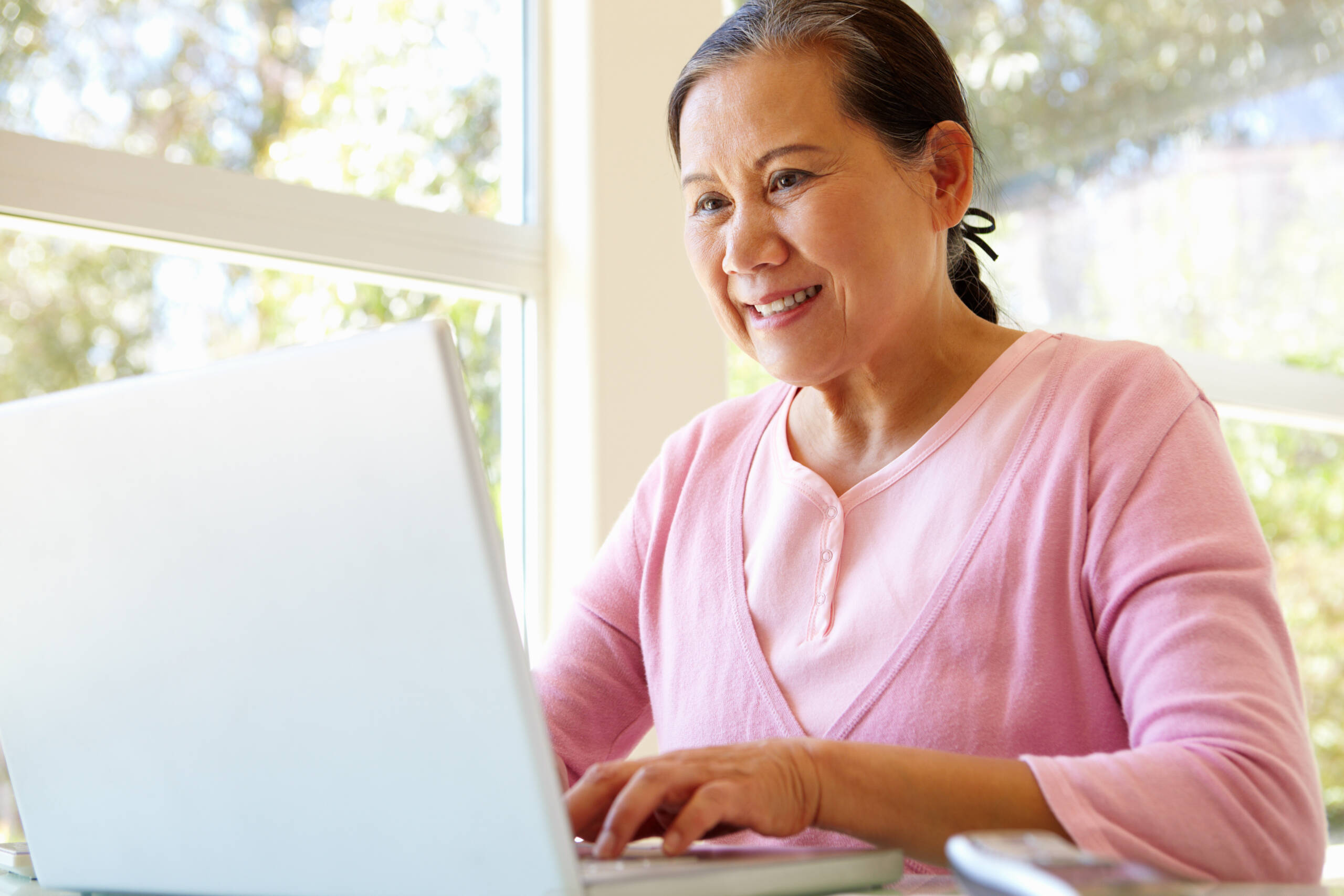 Lady working on laptop smiling