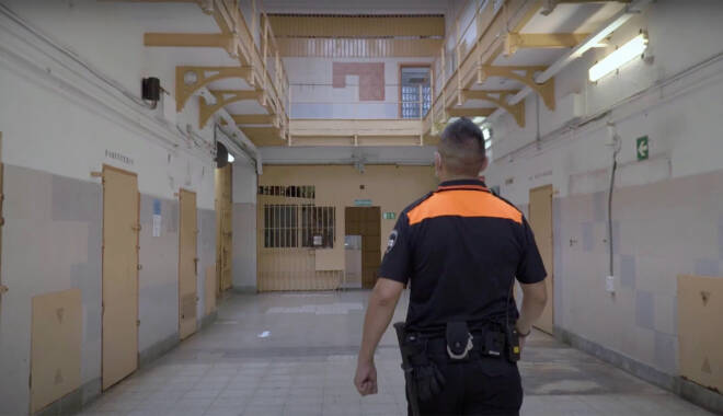 Corrections officer walking through a prison