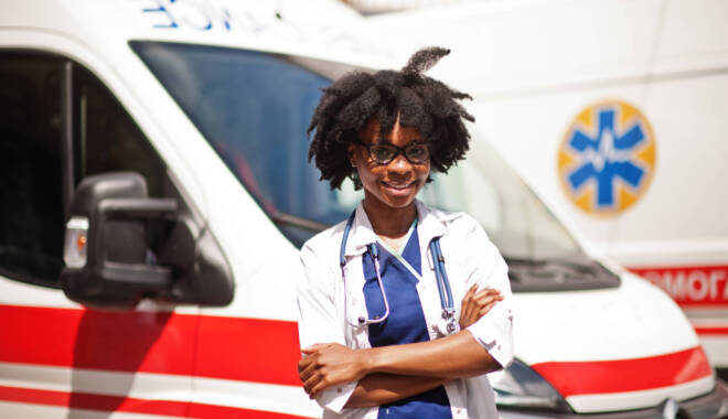 Doctor standing in front of ambulance