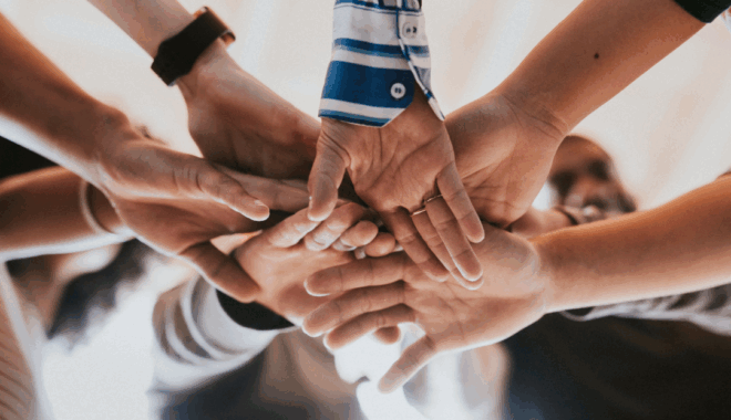 children putting their hands together