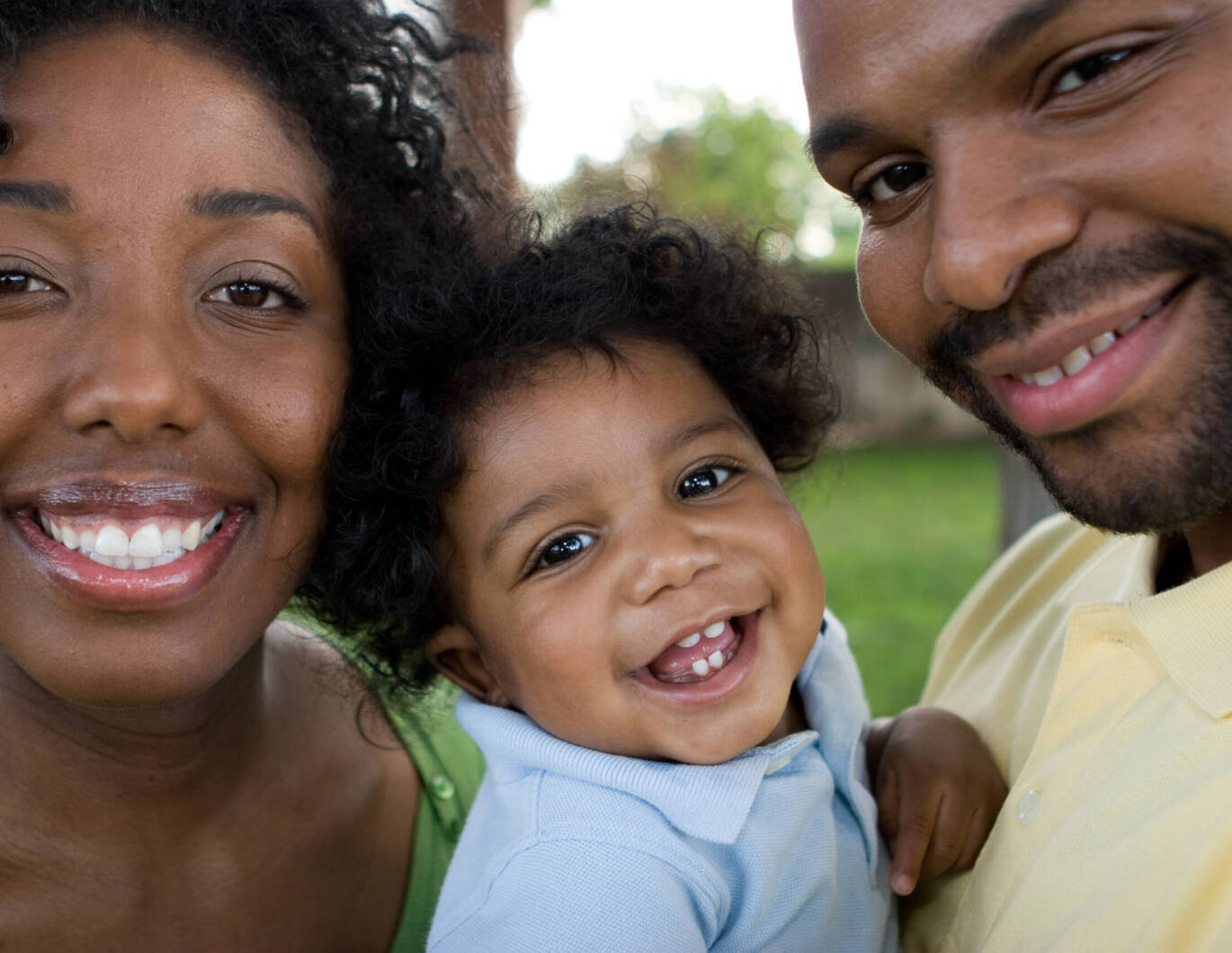 Family with baby smiling