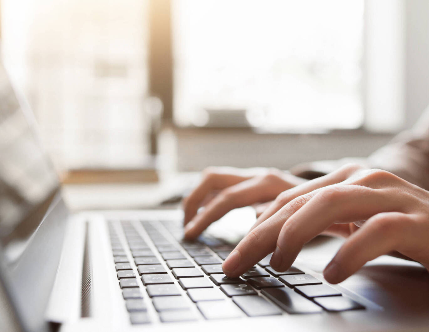Typing on a laptop