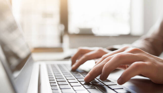 Typing on a laptop