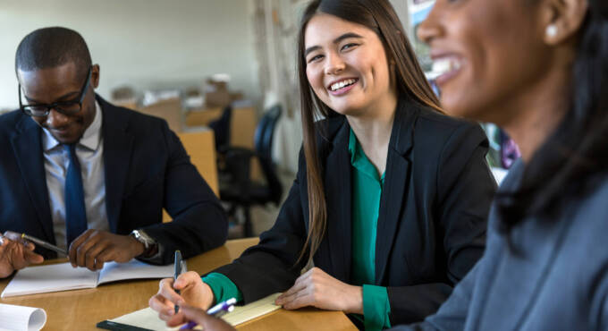 Woman smiling with coworkers in office